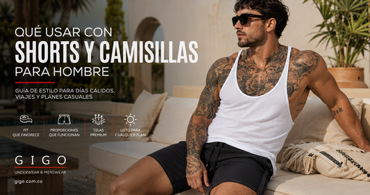 Modelo masculino adulto usando camisilla blanca y short negro de Gigo en un ambiente editorial de clima cálido para una guía sobre cómo combinar shorts y camisillas para hombre.